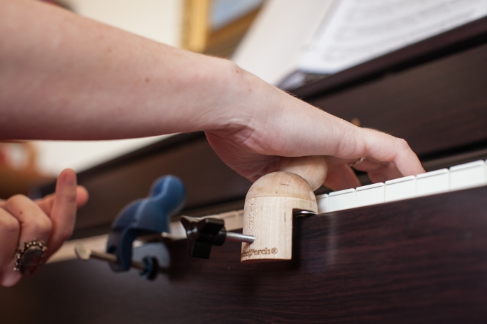Perfect Perch hand support device for piano students with dyspraxia [Photo credit: http://www.outoftheshadowsphotography.com ]