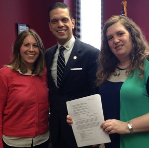 Left to right: Rebecca Botta-Zalucki, Assemblyman Santabarbara, and Henny Kupferstein, holding the signed proposal. 
