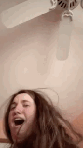 Image Caption: Lindsay simulating a wheezing struggle when breathing near a fan.